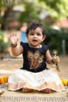 Hand-painted black peacock feather kids top with white and gold Kerala kasavu skirt for girls